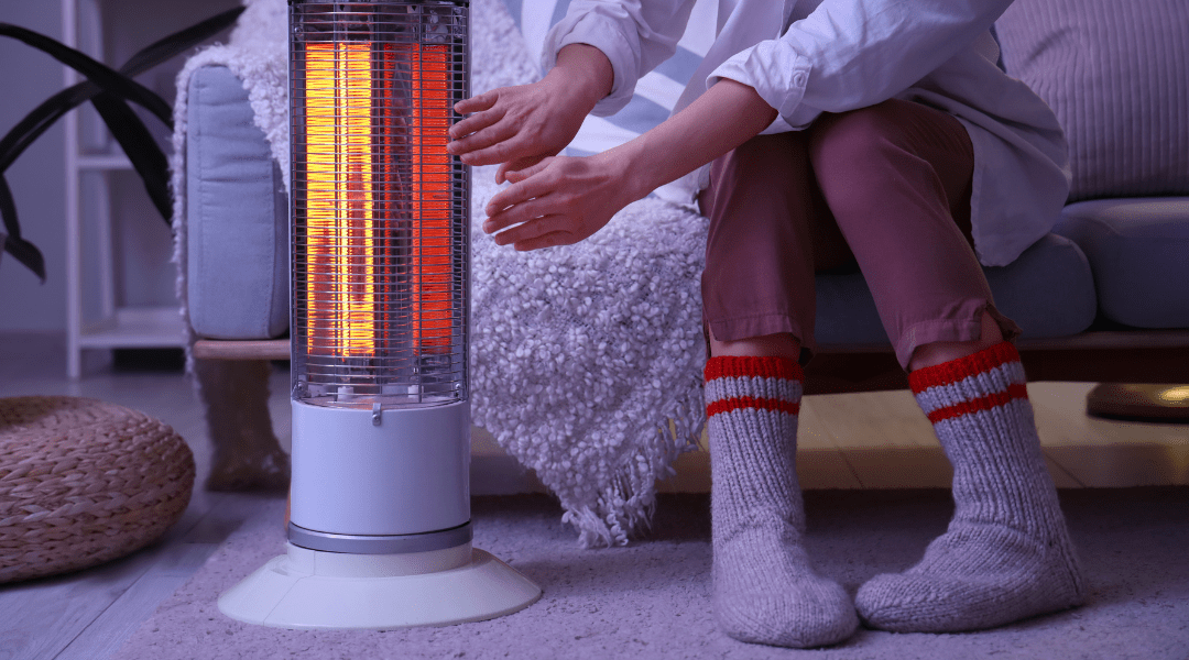 A woman sitting near a space heater, illustrating how repeated heat exposure can damage skin and increase the risk of skin cancer.